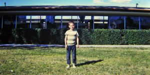Me standing next to school in 1967. I am 6 years old.