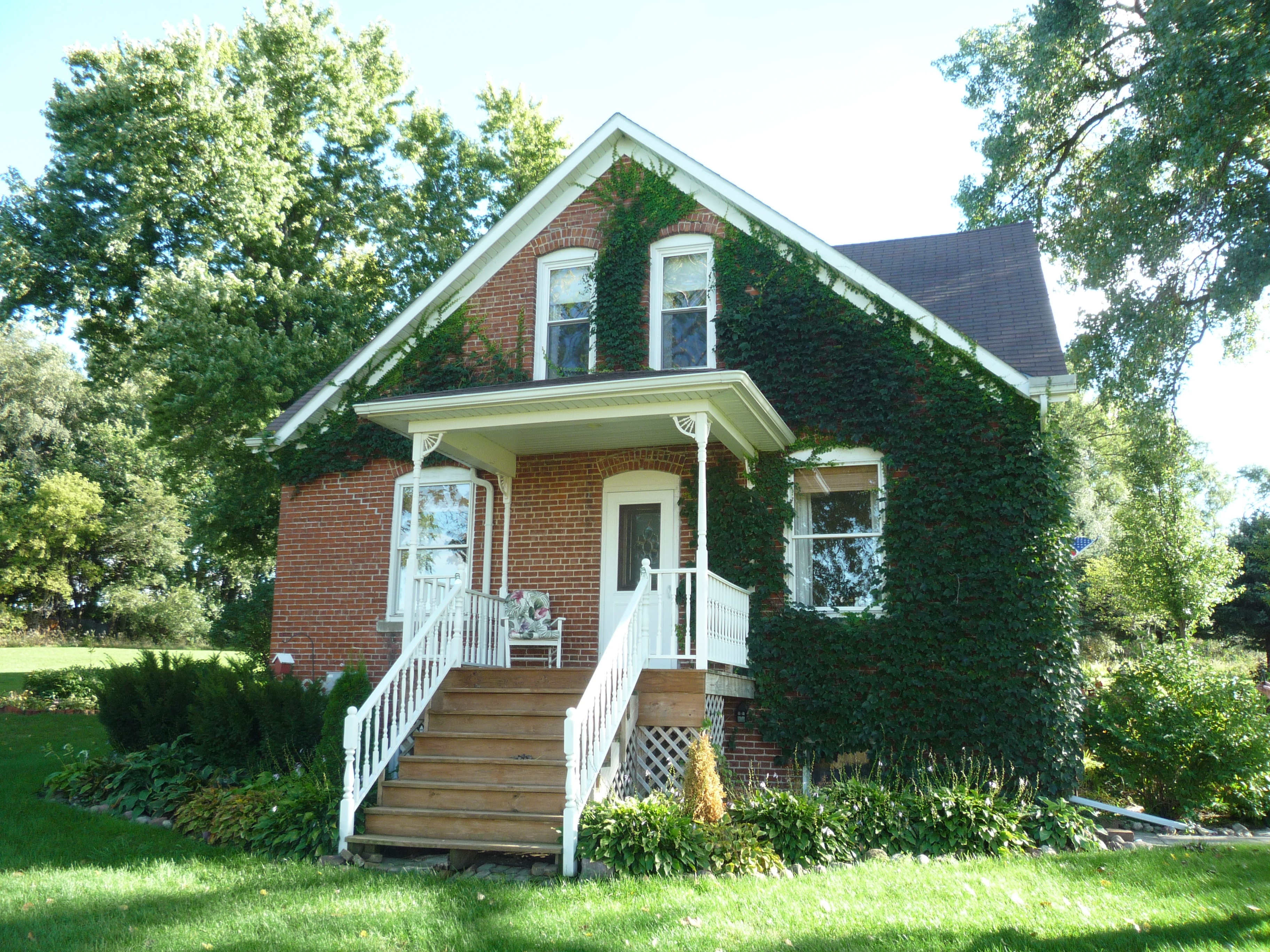 Front of brick house built by my great grandfather.  Now owned by Annette (Overgaard) Anderson.  My mom saved many photos from when the family socialized in this front yard.