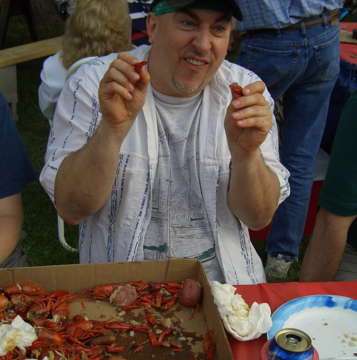 Paul playing with crayfish claws at boil in Troy, Missouri