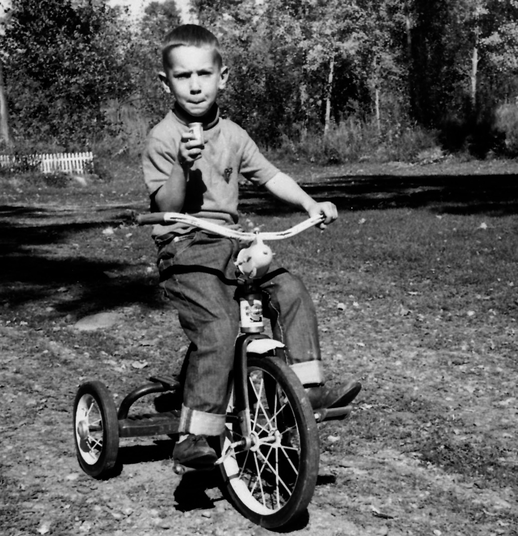 Paul on tricycle in driveway of house in Luck, Wisconsin